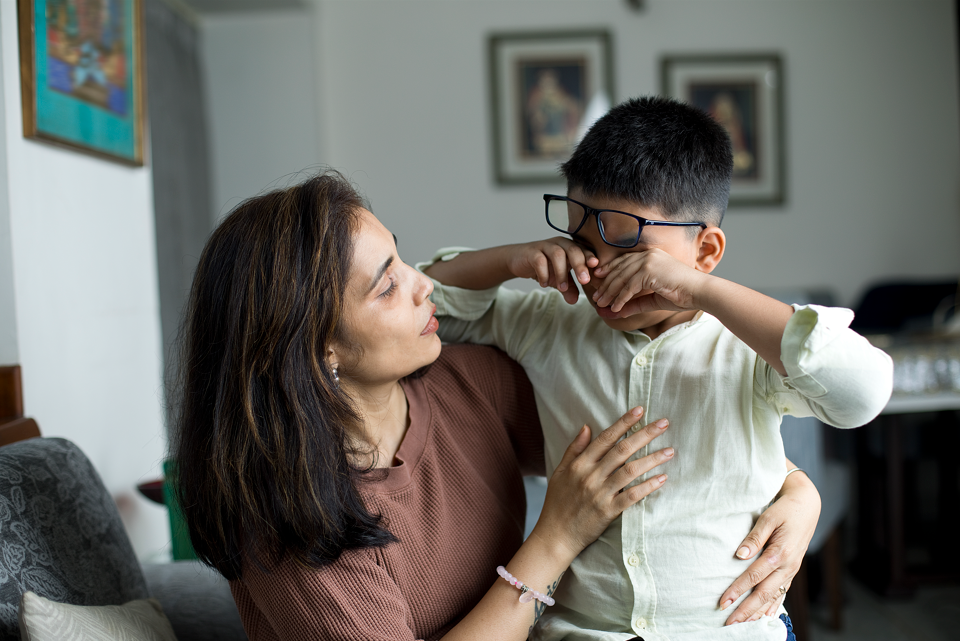 Mother comforting crying boy