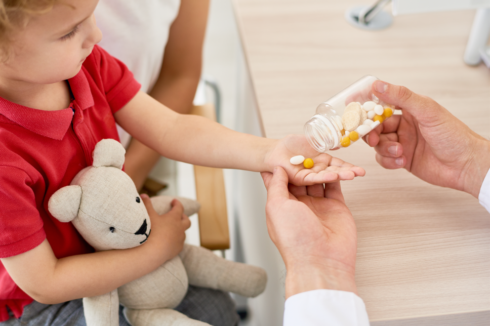 Young child taking daily prescription pills