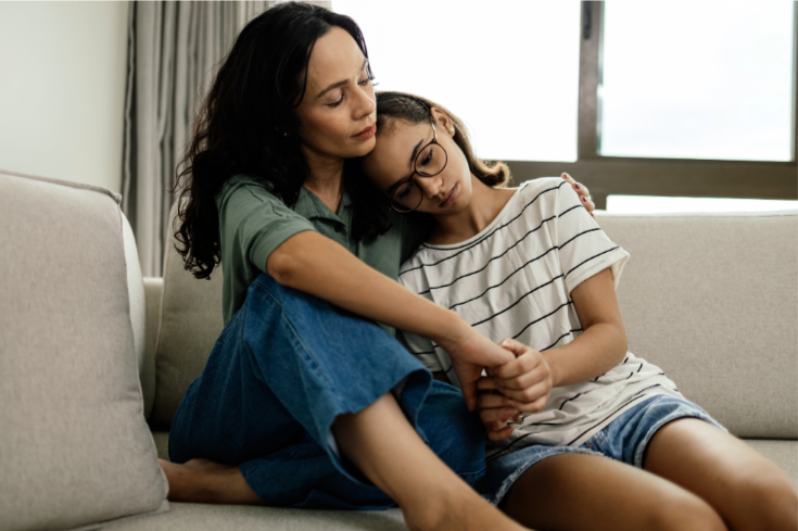 Mother comforting sad teen-age girl