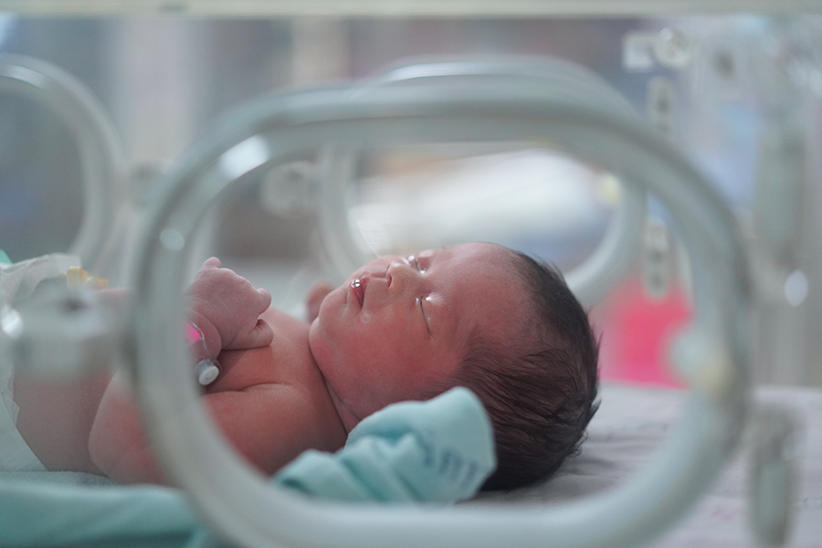 Newborn in incubator