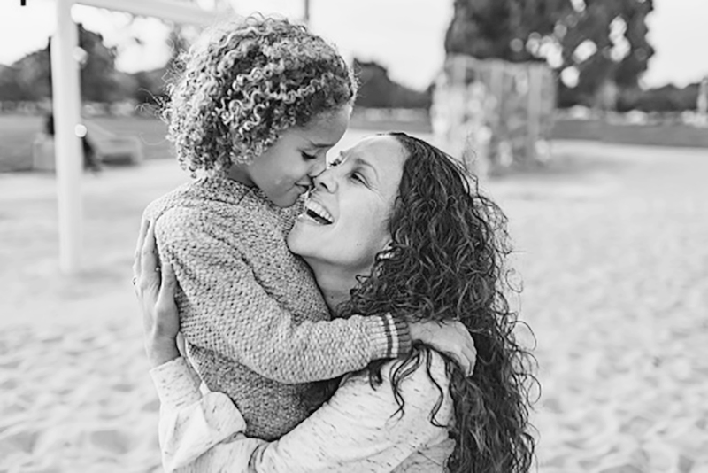 woman and child laughing and hugging